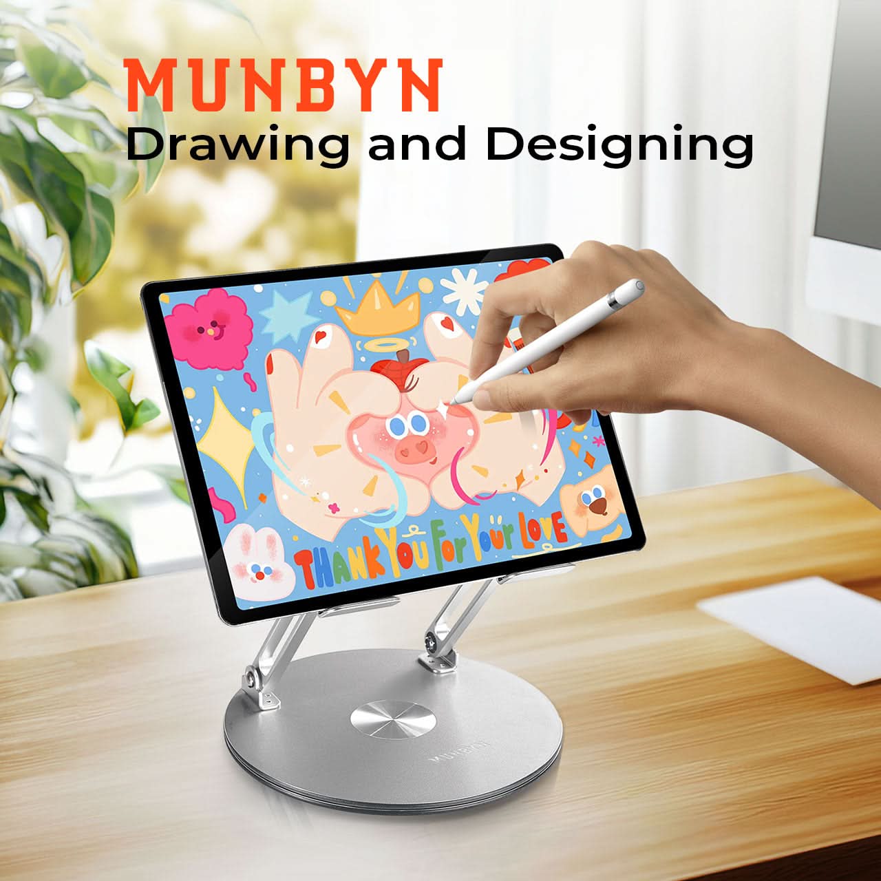 MUNBYN 360° rotating laptop stand on a desk, adjustable height and angle for ergonomic workspace setup.
