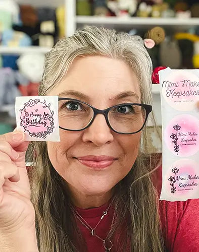 Woman holding two Munbyn custom stickers and labels