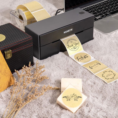 Gold 2-inch label printer paper by MUNBYN, showing shiny gold labels on white backing for use in label printers.